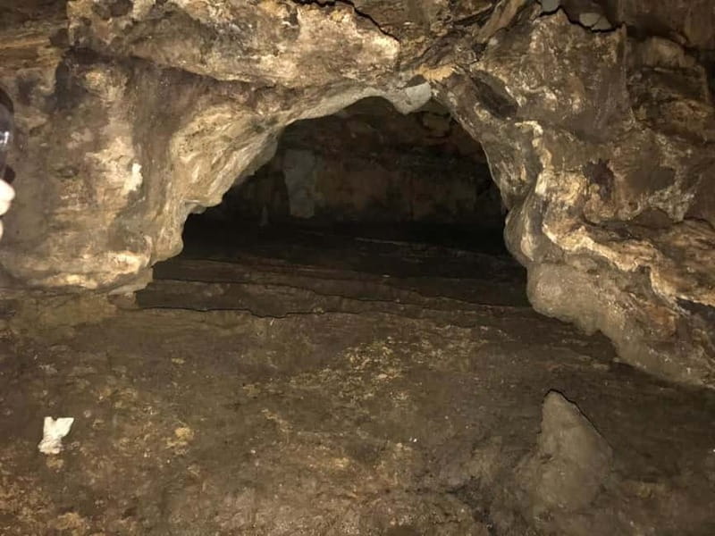 From Tirana: Hiking to Pellumbas Cave & visiting the Canyon - Entering Pellumbas Cave by torchlight